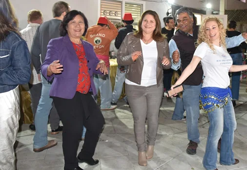 Liang Chao dancing with community members at a cultural celebration