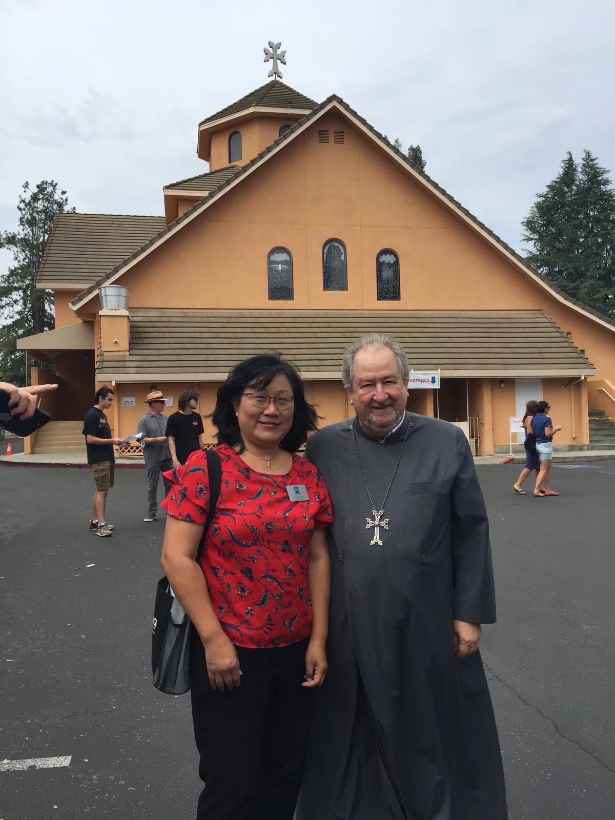 Liang Chao with a faith leader outside a community church