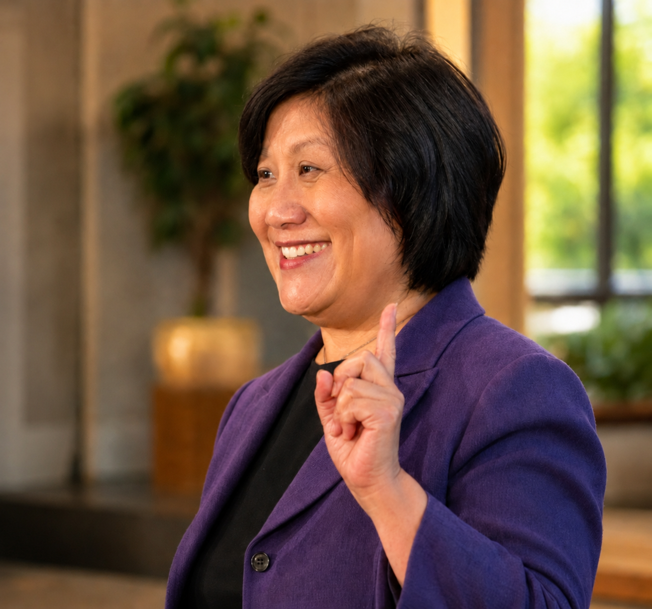 Liang Chao speaking in a purple jacket